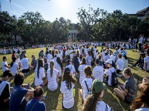 Students sitting outside on campus quad